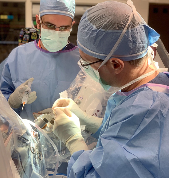 Dr. Gonzalez places a recording microelectrode during a DBS surgery.