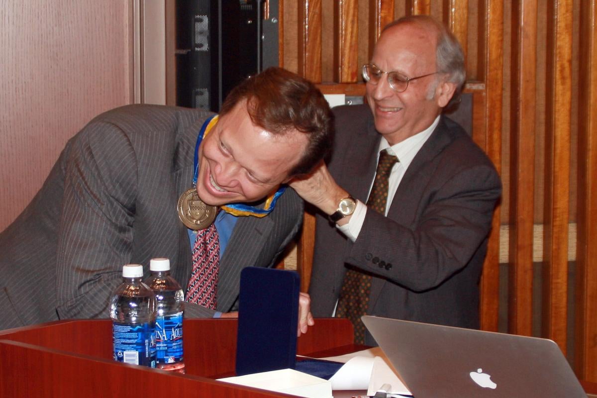 Robert Friedlander receives medal from Arthur Levine