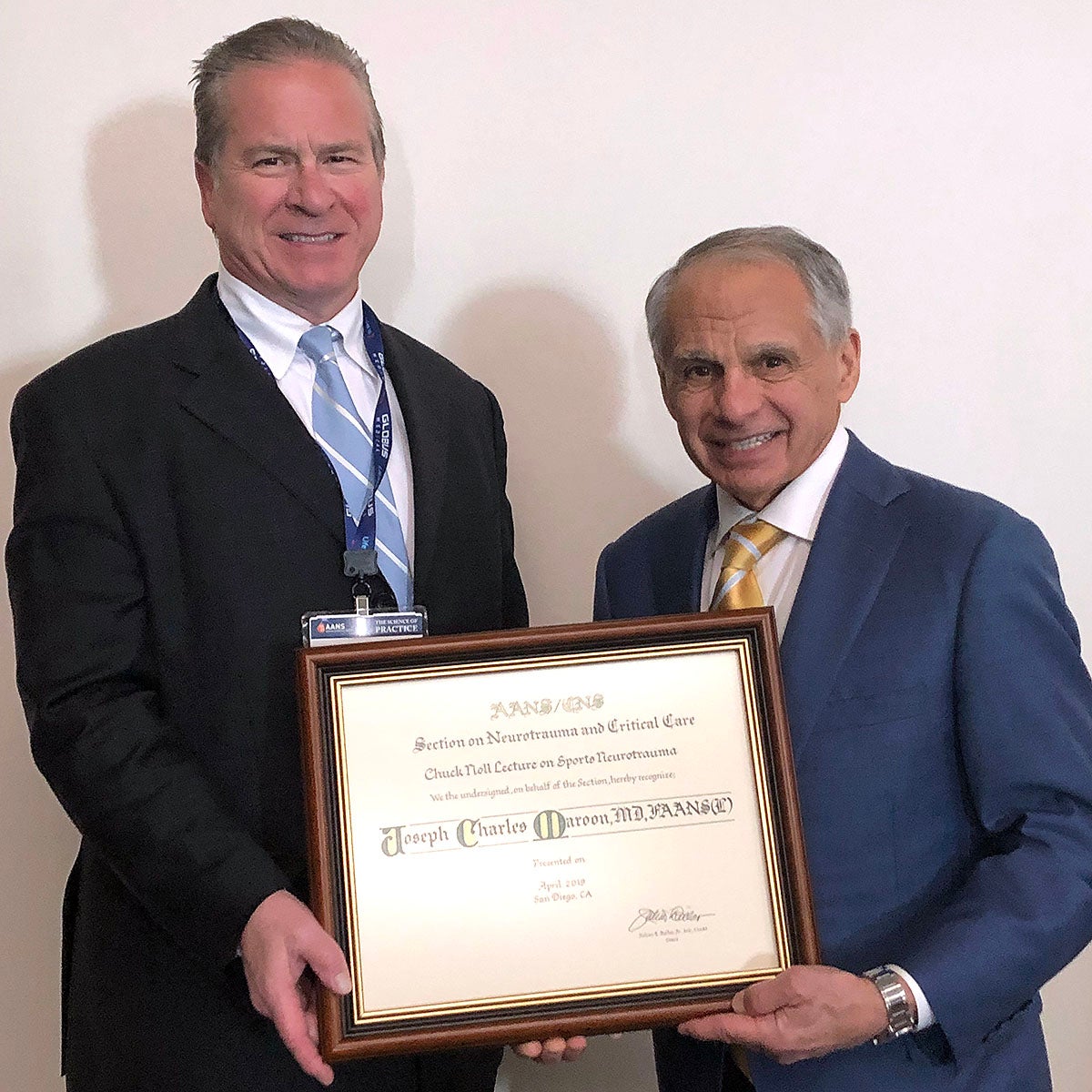 Julian Bailes, MD, presents plaque to Joseph Maroon, MD.